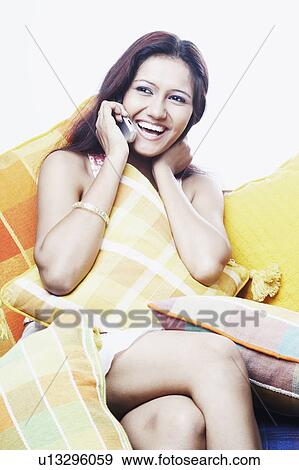 Close-up of a young woman talking on a mobile phone View Large Photo Image Stock Photo - Close-up of a young woman talking on a mobile phone. Fotosearch