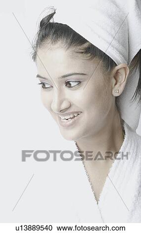 Close-up of a young woman wearing a bathrobe View Large Photo Image Stock Image - Close-up of a young woman wearing a bathrobe. Fotosearch