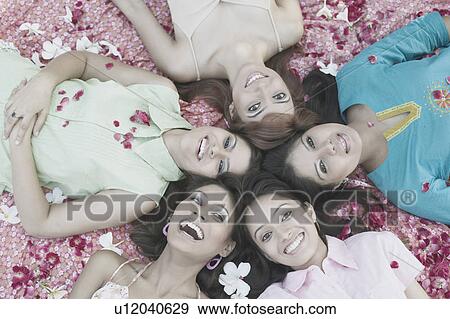 Portrait of a teenage girl and four young women lying on their back View Large Photo Image Stock Photo - Portrait of a teenage girl and four young women lying on their back. Fotosearch