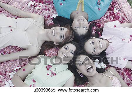 Portrait of a teenage girl and four young women lying on their back View Large Photo Image Stock Photography - Portrait of a teenage girl and four young women lying on their back. Fotosearch