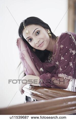 Portrait of a teenage girl leaning over a railing View Large Photo Image Stock Photo - Portrait of a teenage girl leaning over a railing. Fotosearch