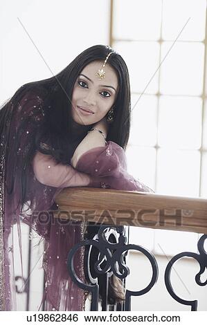 Portrait of a teenage girl leaning over a railing View Large Photo Image Stock Photograph - Portrait of a teenage girl leaning over a railing. Fotosearch