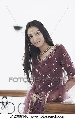 Portrait of a teenage girl standing in the balcony View Large Photo Image Stock Photograph - Portrait of a teenage girl standing in the balcony. Fotosearch