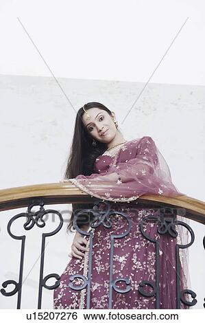 Portrait of a teenage girl standing in the balcony View Large Photo Image Stock Photograph - Portrait of a teenage girl standing in the balcony. Fotosearch