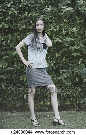 Portrait of a teenage girl standing with her hand on her hip View Large Photo Image Picture - Portrait of a teenage girl standing with her hand on her hip. Fotosearch