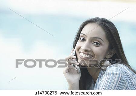 Stock Photography - Portrait of a teenage girl talking on a mobile phone. Fotosearch