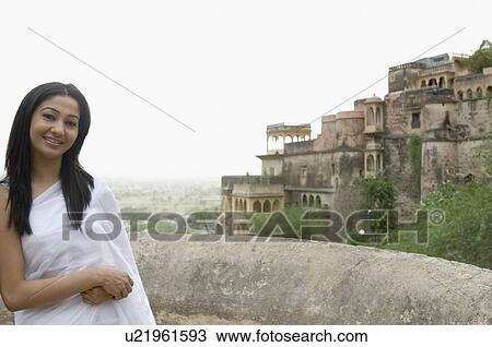 Stock Image - Portrait of a young woman smiling, Neemrana Fort, Alwar, Rajasthan, India. Fotosearch