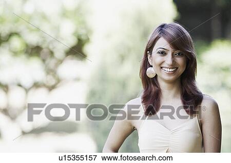 Portrait of a young woman smiling View Large Photo Image Stock Photo - Portrait of a young woman smiling. Fotosearch