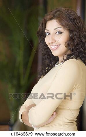 Portrait of a young woman smiling View Large Photo Image Stock Photo - Portrait of a young woman smiling. Fotosearch