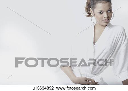 Portrait of a young woman wearing a bathrobe View Large Photo Image Stock Image - Portrait of a young woman wearing a bathrobe. Fotosearch