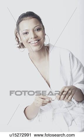 Portrait of a young woman wearing earphones listening to music View Large Photo Image Stock Image - Portrait of a young woman wearing earphones listening to music. Fotosearch