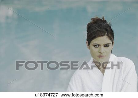 Portrait of a young woman with a facial mask standing at the poolside View Large Photo Image Stock Photo - Portrait of a young woman with a facial mask standing at the poolside. Fotosearch