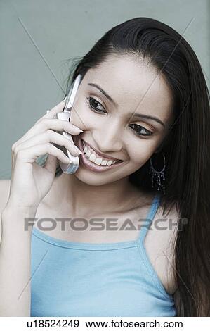 Close-up of a teenage girl talking on a mobile phone View Large Photo Image Stock Photo - Close-up of a teenage girl talking on a mobile phone. Fotosearch