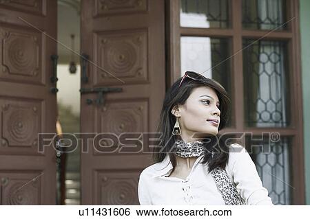 Close-up of a young woman with sunglasses on her head View Large Photo Image Stock Photograph - Close-up of a young woman with sunglasses on her head. Fotosearch