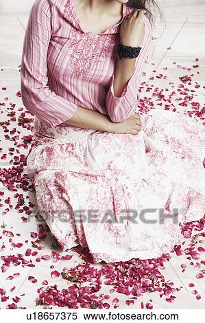 High angle view of a young woman sitting on the floor View Large Photo Image Stock Photography - High angle view of a young woman sitting on the floor. Fotosearch