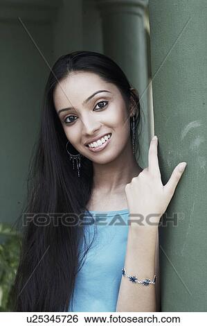 Portrait of a teenage girl leaning against a column smiling View Large Photo Image Stock Photograph - Portrait of a teenage girl leaning against a column smiling. Fotosearch