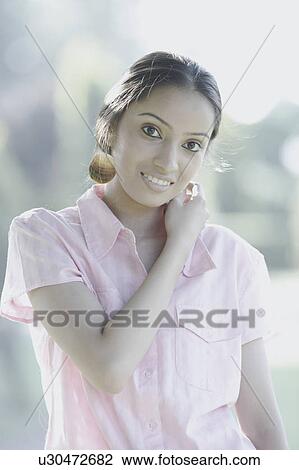 Stock Image - Portrait of a teenage girl smiling. Fotosearch