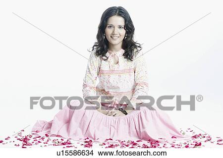 Picture - Portrait of a young woman sitting and smiling. Fotosearch