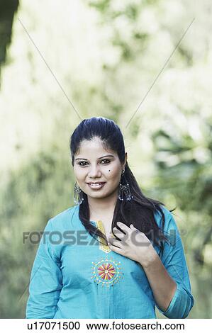 Portrait of a young woman smiling View Large Photo Image Stock Image - Portrait of a young woman smiling. Fotosearch