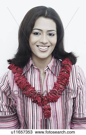 Portrait of a young woman wearing a garland View Large Photo Image Stock Image - Portrait of a young woman wearing a garland. Fotosearch