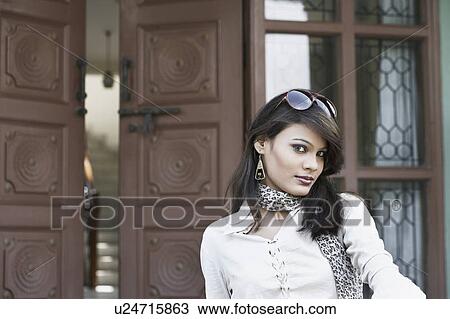 Portrait of a young woman with sunglasses on her head View Large Photo Image Stock Image - Portrait of a young woman with sunglasses on her head. Fotosearch