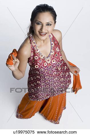 High angle view of a mid adult woman standing in salwar kameez and smiling View Large Photo Image Stock Photography - High angle view of a mid adult woman standing in salwar kameez and smiling. Fotosearch