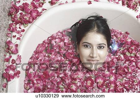 High angle view of a young woman lying in a bathtub covered with flower petals View Large Photo Image Stock Photo - High angle view of a young woman lying in a bathtub covered with flower petals. Fotosearch