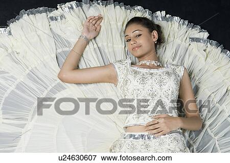 High angle view of a young woman lying in lehenga choli View Large Photo Image Stock Photo - High angle view of a young woman lying in lehenga choli. Fotosearch