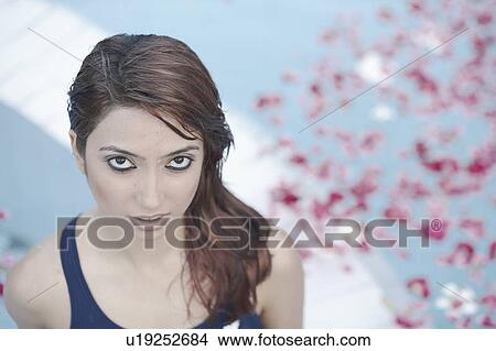 High angle view of a young woman standing in a swimming pool View Large Photo Image Picture - High angle view of a young woman standing in a swimming pool. Fotosearch