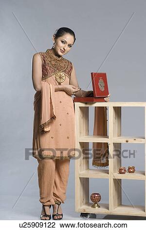 Portrait of a mid adult woman in salwar kameez and holding a jewelry box View Large Photo Image Stock Image - Portrait of a mid adult woman in salwar kameez and holding a jewelry box. Fotosearch