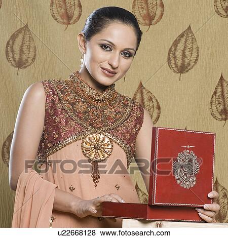 Portrait of a mid adult woman in salwar kameez and holding a jewelry box View Large Photo Image Stock Photo - Portrait of a mid adult woman in salwar kameez and holding a jewelry box. Fotosearch