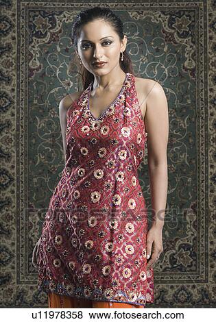 Portrait of a mid adult woman standing in salwar kameez View Large Photo Image Stock Photo - Portrait of a mid adult woman standing in salwar kameez. Fotosearch