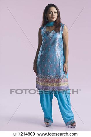 Portrait of a mid adult woman standing in salwar kameez View Large Photo Image Stock Photo - Portrait of a mid adult woman standing in salwar kameez. Fotosearch