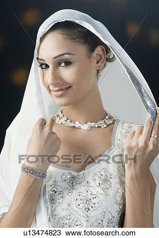 Stock Image - Portrait of a young woman in lehenga choli. Fotosearch
