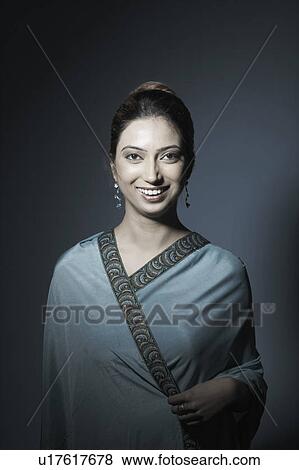 Portrait of a young woman smiling View Large Photo Image Stock Photo - Portrait of a young woman smiling. Fotosearch