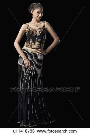 Portrait of a young woman standing in lehenga choli View Large Photo Image Stock Image - Portrait of a young woman standing in lehenga choli. Fotosearch