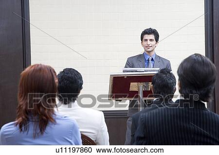 Businessman giving presentation in a conference room View Large Photo Image Stock Image - Businessman giving presentation in a conference room. Fotosearch