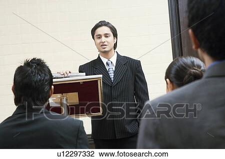 Businessman giving presentation in a conference room View Large Photo Image Stock Image - Businessman giving presentation in a conference room. Fotosearch