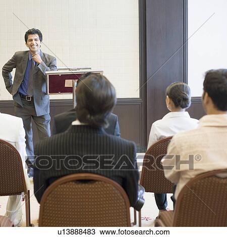 Businessman giving speech in a seminar View Large Photo Image Stock Image - Businessman giving speech in a seminar. Fotosearch