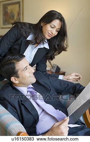 Close-up of a businessman holding a file with a businesswoman standing beside him View Large Photo Image Stock Image - Close-up of a businessman holding a file with a businesswoman standing beside him. Fotosearch