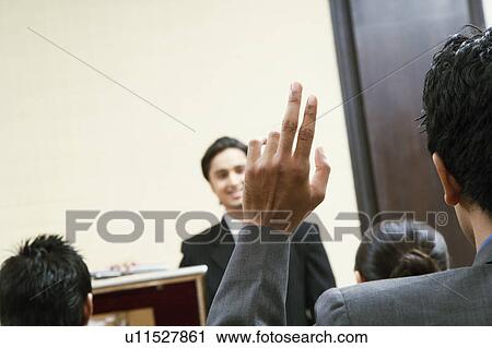 Stock Image - Four business executives in a conference room. Fotosearch