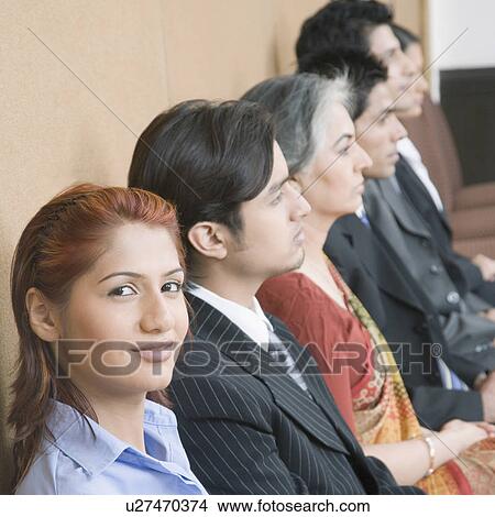 Portrait of a businesswoman sitting with five business executives and smiling View Large Photo Image Picture - Portrait of a businesswoman sitting with five business executives and smiling. Fotosearch