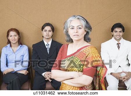 Portrait of a businesswoman standing in front of three business executives View Large Photo Image Stock Image - Portrait of a businesswoman standing in front of three business executives. Fotosearch