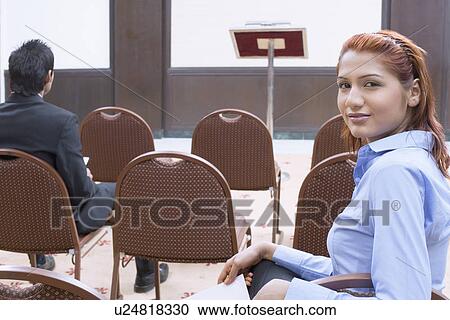 Portrait of a businesswoman with a businessman sitting in a conference room View Large Photo Image Stock Image - Portrait of a businesswoman with a businessman sitting in a conference room. Fotosearch