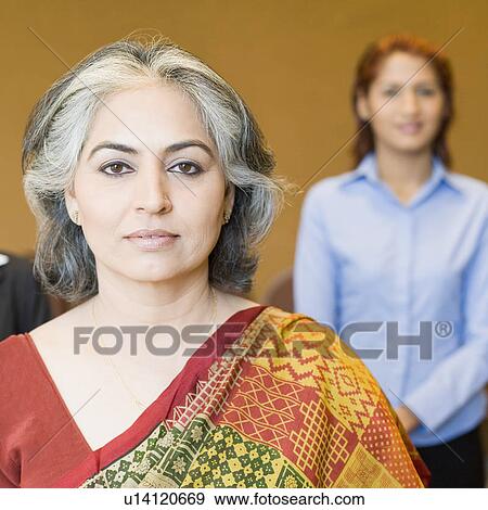 Portrait of a businesswoman with her colleague in the background View Large Photo Image Stock Photo - Portrait of a businesswoman with her colleague in the background. Fotosearch