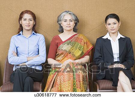 Portrait of three businesswomen sitting on chairs View Large Photo Image Stock Photo - Portrait of three businesswomen sitting on chairs. Fotosearch