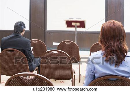 Rear view of two business executives sitting in a conference room View Large Photo Image Stock Image - Rear view of two business executives sitting in a conference room. Fotosearch