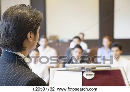 Side profile of a businessman giving presentation in a conference room View Large Photo Image Stock Image - Side profile of a businessman giving presentation in a conference room. Fotosearch