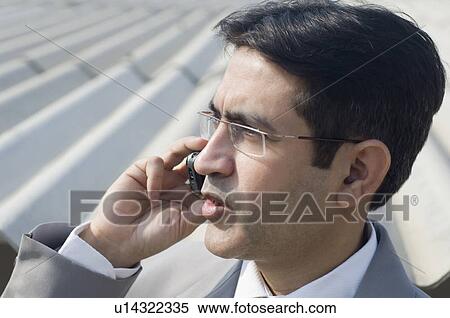 Stock Photography - Close-up of a businessman talking on a mobile phone. Fotosearch