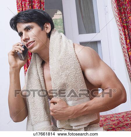Picture - Close-up of a young man talking on a mobile phone. Fotosearch